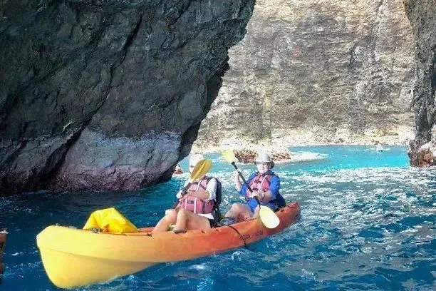 A tandem kayak at the mouth of a Na Pali sea cave