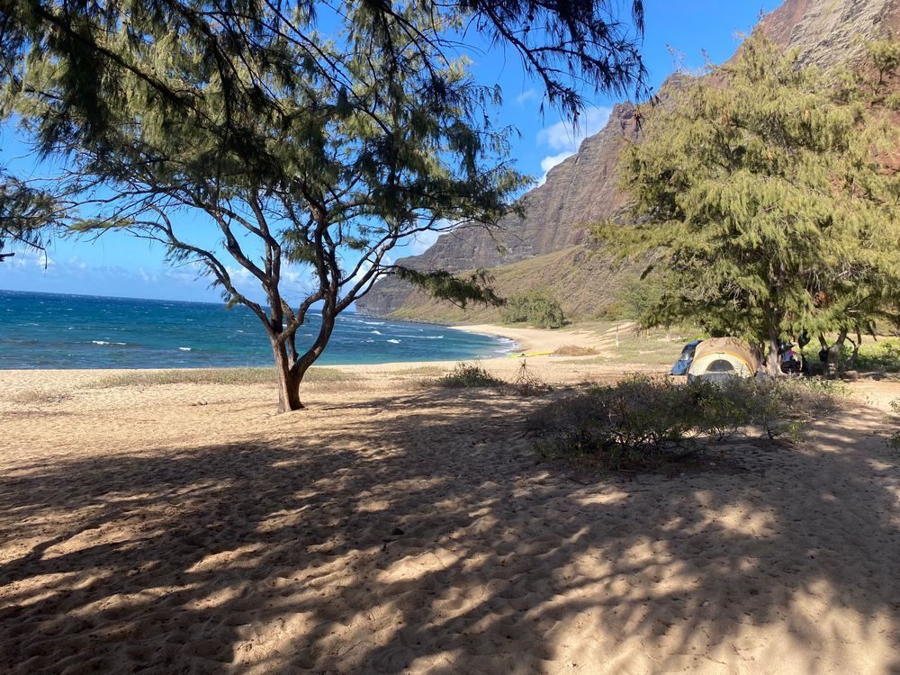 Camp set up on the sand at a remote Na Pali Coast beach, Kauai