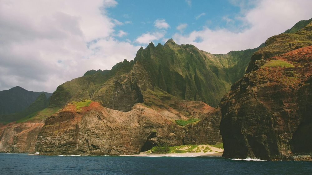 The Na Pali Coast cliffs above a beach on Kauai's northwest shore