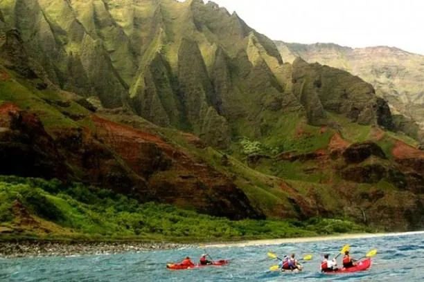 Sea kayaking Kauai along Na Pali Coast cliffs and caves